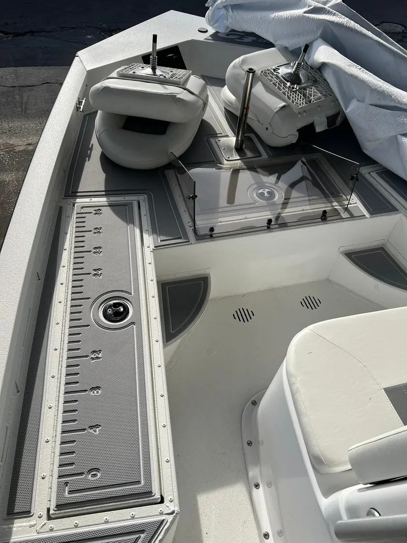 Slide: The Image of 2025 G3 Bay 19 GX boat interior with cushioned seating and storage compartments. - 6