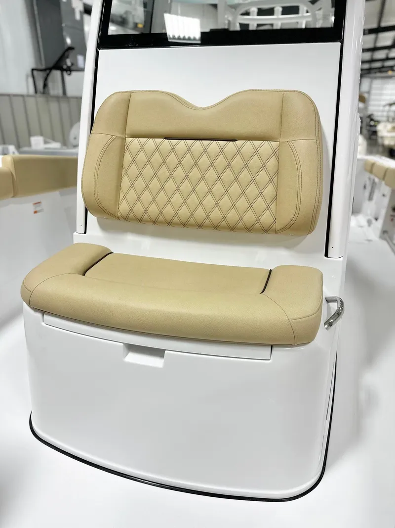 Slide: The Image of 2025 Sportsman Open 282 Center Console boat seat with beige upholstery and diamond stitching. - 11