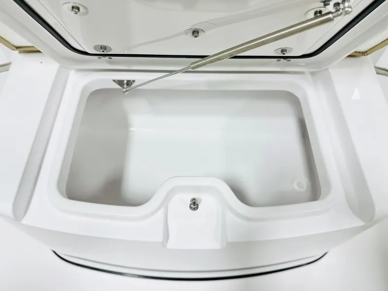 Slide: The Image of Open storage compartment on 2025 Sportsman Open 282 Center Console boat. - 12