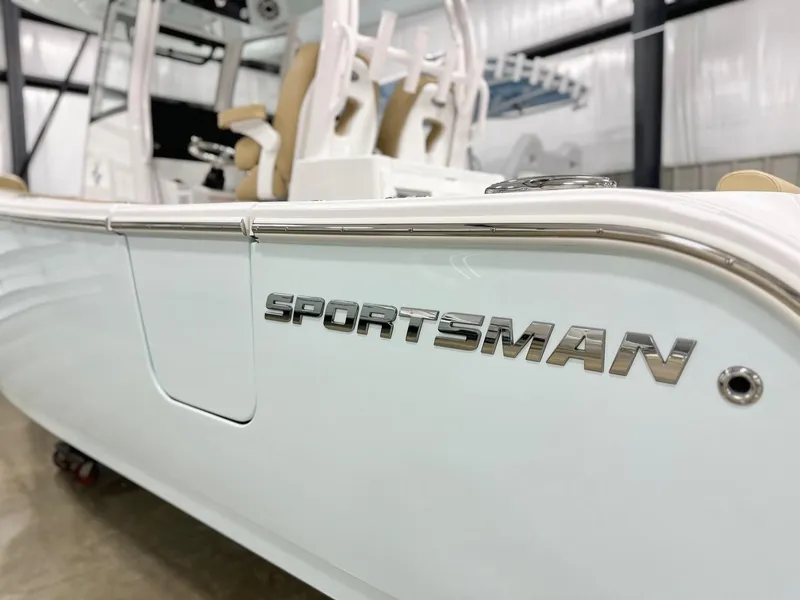Slide: The Image of 2025 Sportsman Open 282 Center Console boat in showroom, featuring sleek design and branding. - 20