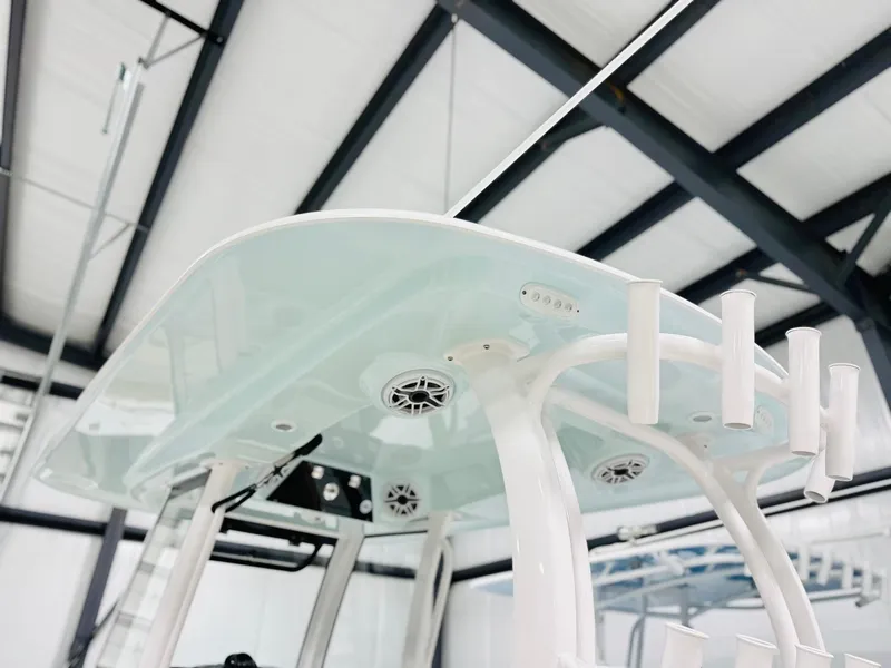 Slide: The Image of 2025 Sportsman Open 282 Center Console boat's T-top with rod holders and speakers. - 6