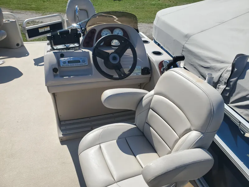 Slide: The Image of 2012 Starcraft Stardeck 206 4PT boat interior with steering wheel and captain's chair. - 3