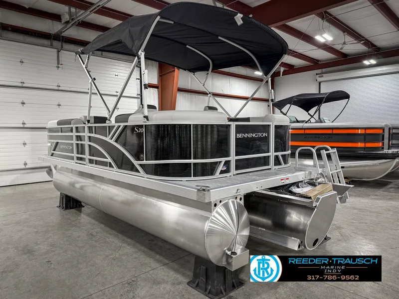 Slide: The Image of 2025 Bennington 20 SSR pontoon boat in showroom with canopy and sleek design. - 10