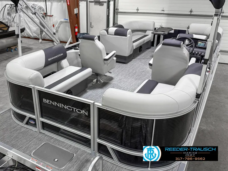 Slide: The Image of 2025 Bennington 20 SSR pontoon boat with spacious seating and modern design in a showroom. - 14
