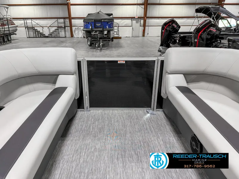 Slide: The Image of 2025 Bennington 20 SSR pontoon boat interior with gray seating in a showroom. - 18