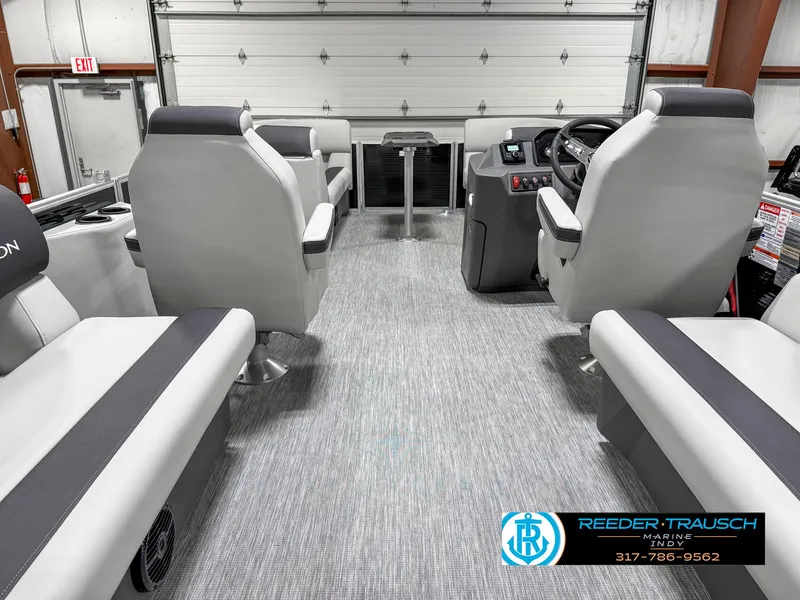 Slide: The Image of 2025 Bennington 20 SSR interior with modern seating and control panel in a showroom. - 19