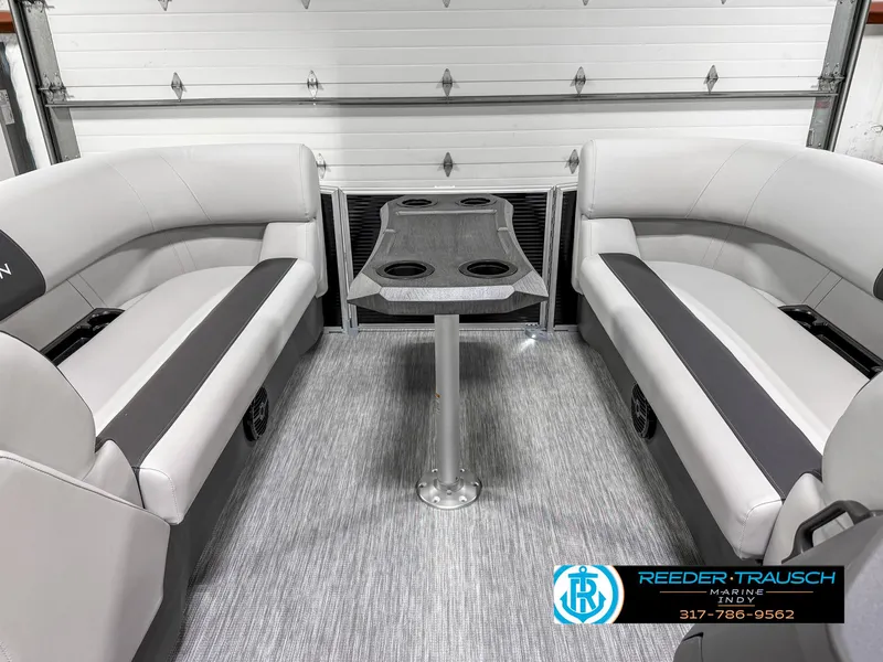 Slide: The Image of 2025 Bennington 20 SSR boat interior with gray seating and table, Reeder-Trausch logo visible. - 21