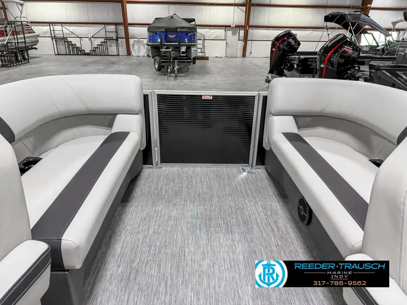 Slide: The Image of Interior of 2025 Bennington 20 SSR pontoon boat with gray seating in a showroom. - 26