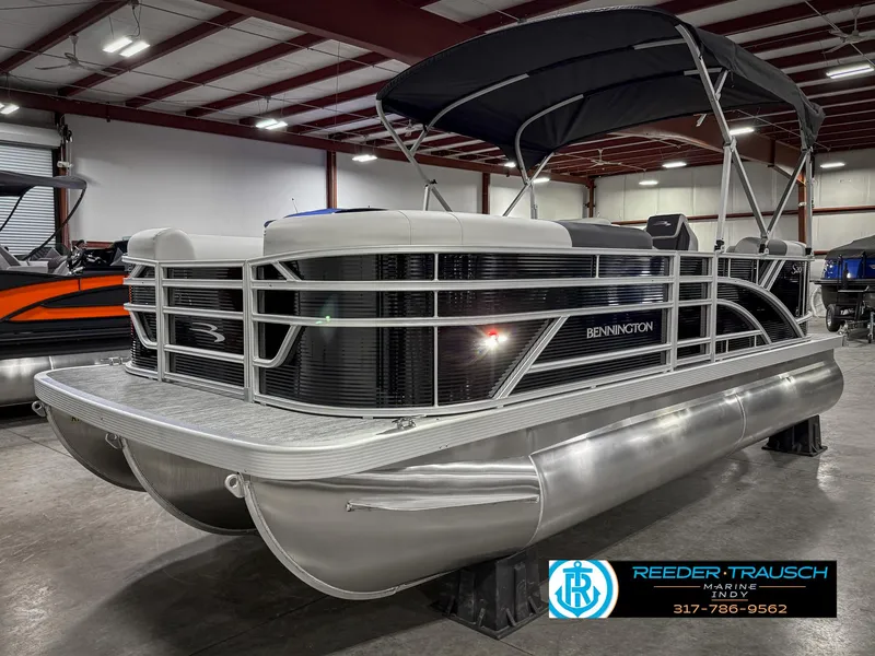 Slide: The Image of 2025 Bennington 20 SSR pontoon boat in showroom with canopy and sleek design. - 3