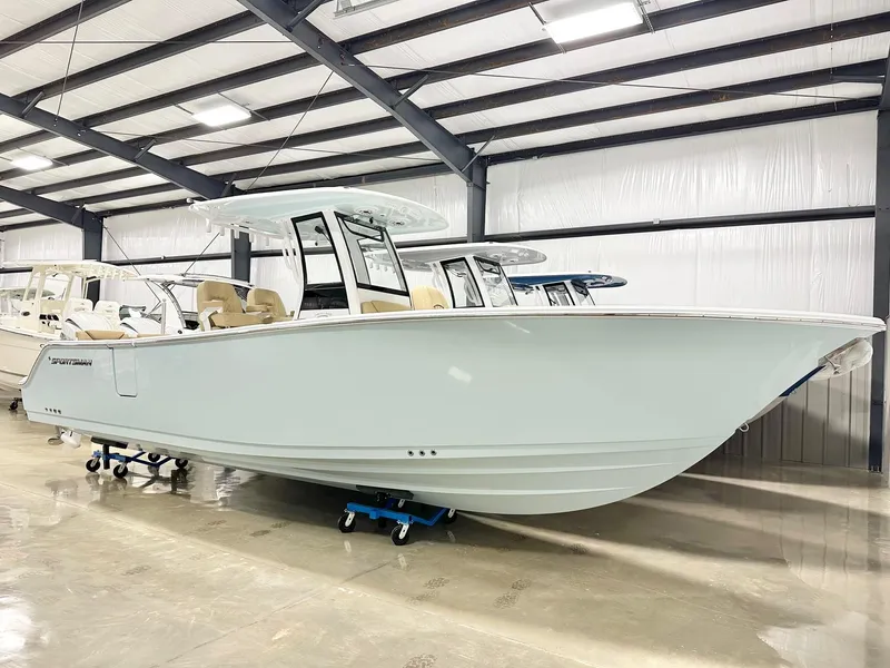 Slide: The Image of 2025 Sportsman Heritage 261 boat in a showroom, showcasing sleek design and modern features. - 1