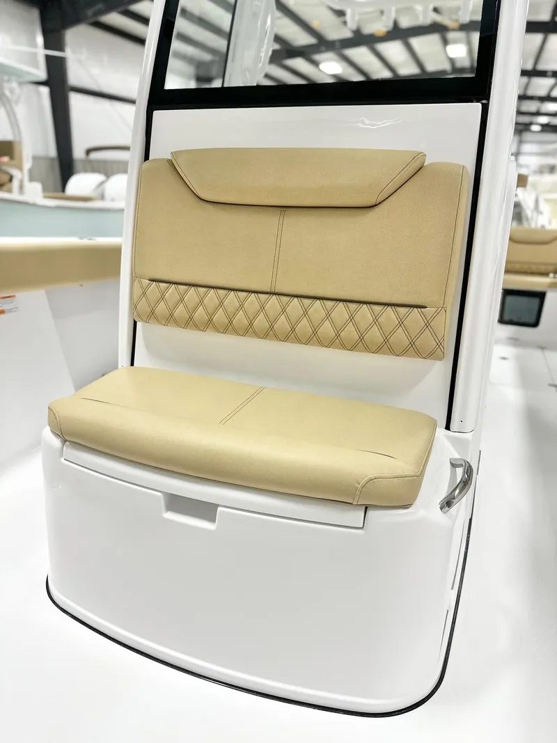 Slide: The Image of 2025 Sportsman Heritage 261 boat seat with beige upholstery and diamond pattern design. - 11
