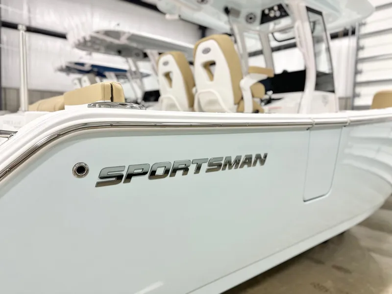 Slide: The Image of 2025 Sportsman Heritage 261 boat with sleek design in a showroom setting. - 16