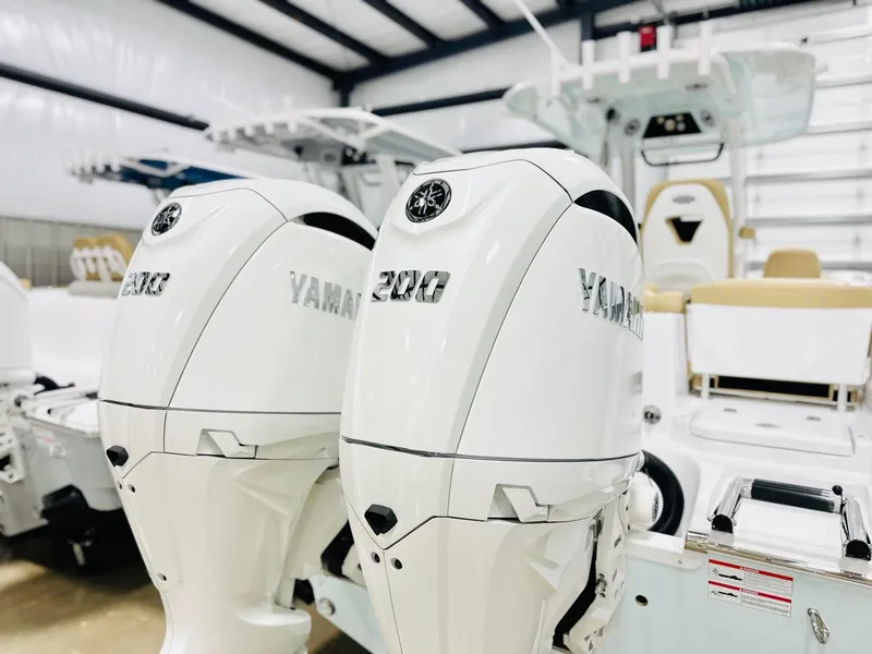 Slide: The Image of 2025 Sportsman Heritage 261 boat with dual Yamaha 300 engines in a showroom. - 17