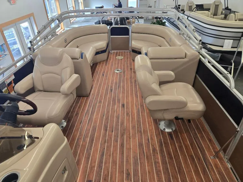 Slide: The Image of 2014 South Bay 522R pontoon boat interior with beige seating and wood-style flooring. - 3