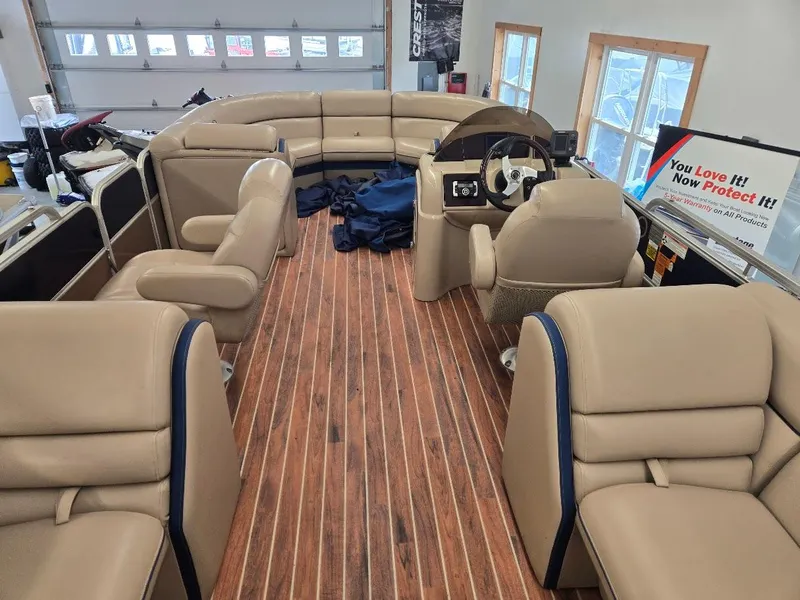 Slide: The Image of Interior of 2014 South Bay 522R pontoon boat with beige seating and wood flooring. - 4