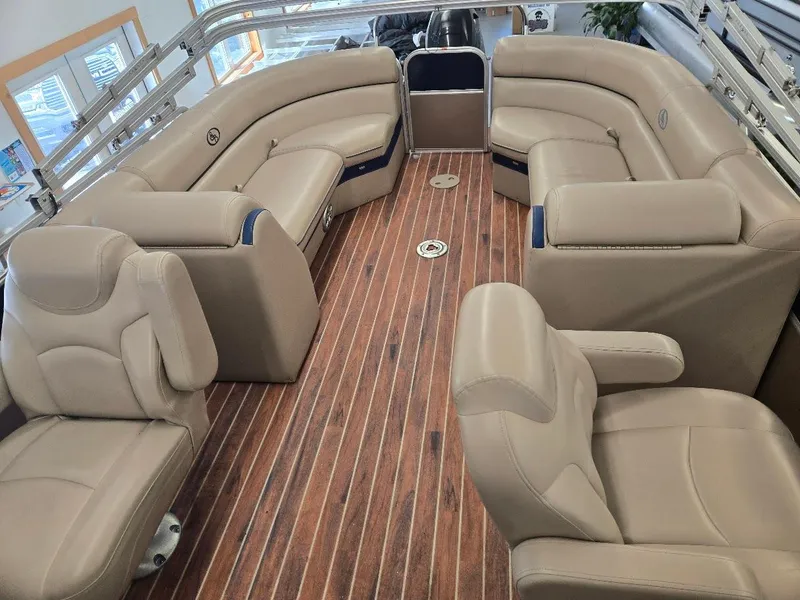 Slide: The Image of 2014 South Bay 522R pontoon boat interior with beige seating and wood-style flooring. - 5