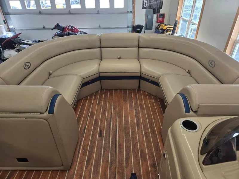 Slide: The Image of Luxurious interior of a 2014 South Bay 522R pontoon boat with tan seating and wood flooring. - 7