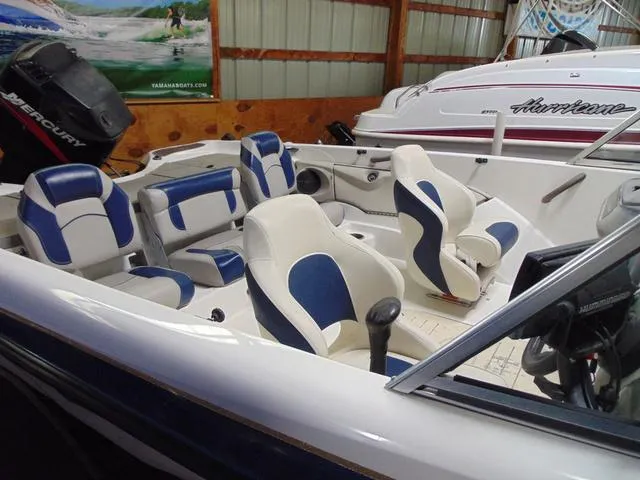 Slide: The Image of 2002 Nitro 188 Fish And Ski boat interior with blue and white seating. - 3