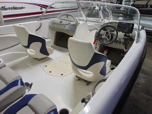 Slide: The Image of 2002 Nitro 188 Fish And Ski boat interior with steering wheel and seating. - 4