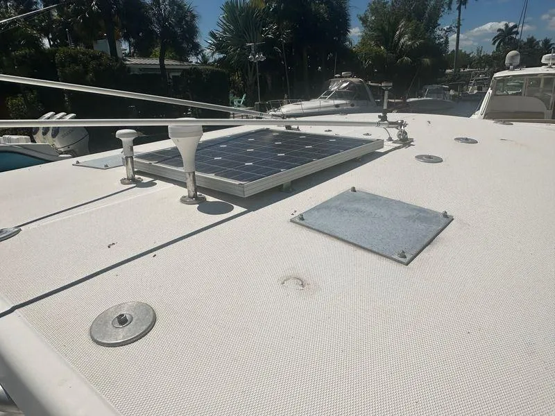 Slide: The Image of 2005 Century 3200 Center Console boat with solar panel on deck, docked under clear sky. - 11