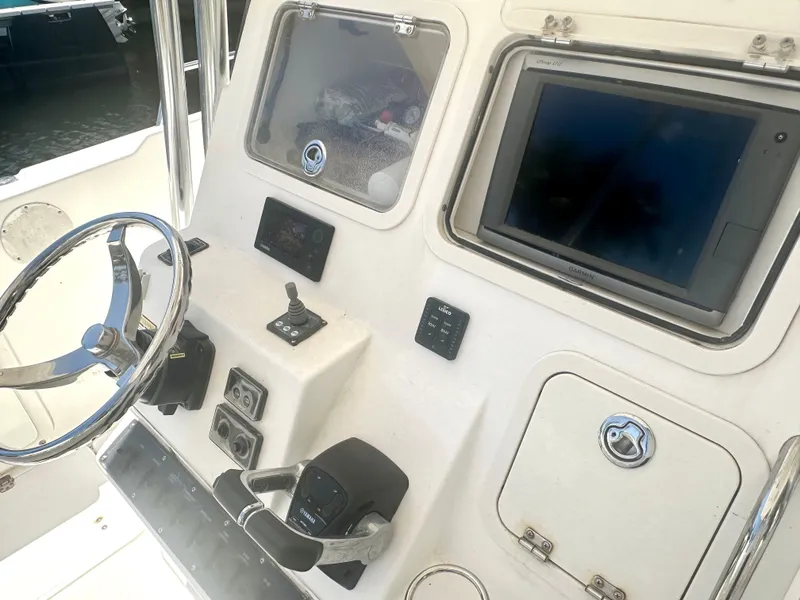 Slide: The Image of 2005 Century 3200 Center Console boat dashboard with steering wheel and electronic controls. - 13