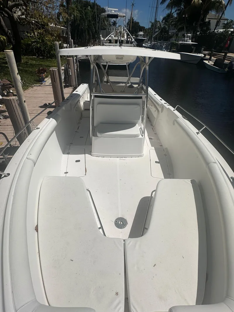 Slide: The Image of 2005 Century 3200 Center Console boat docked by a canal under clear skies. - 19
