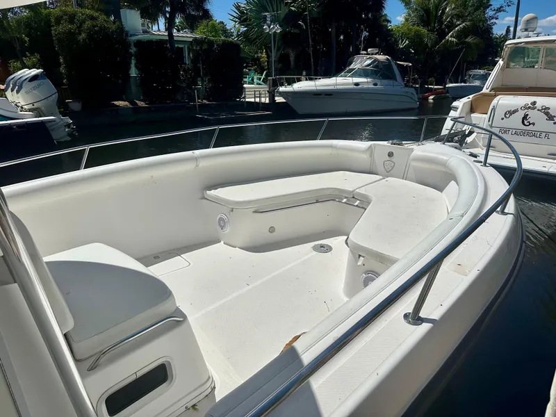 Slide: The Image of 2005 Century 3200 Center Console boat with spacious seating, docked in a marina. - 20