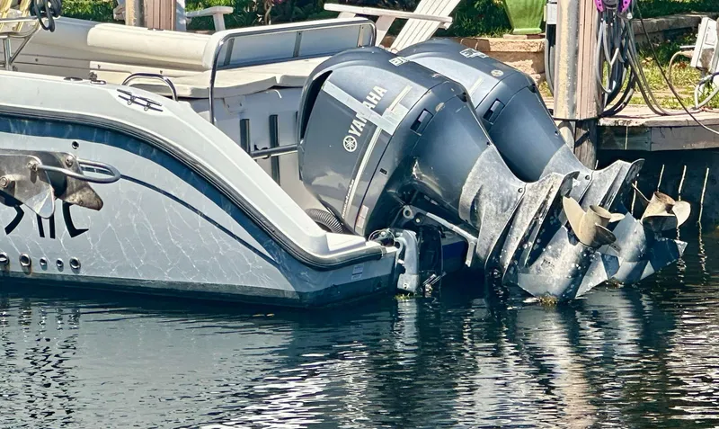 Slide: The Image of 2005 Century 3200 Center Console boat with dual Yamaha outboard motors docked in water. - 24