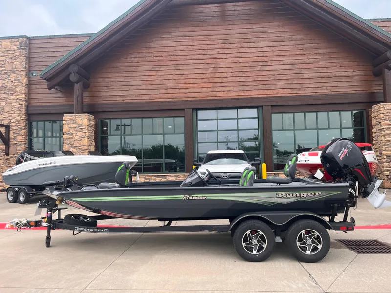 The Image of 2025 Ranger RT198P boat on trailer in front of rustic building. - 0