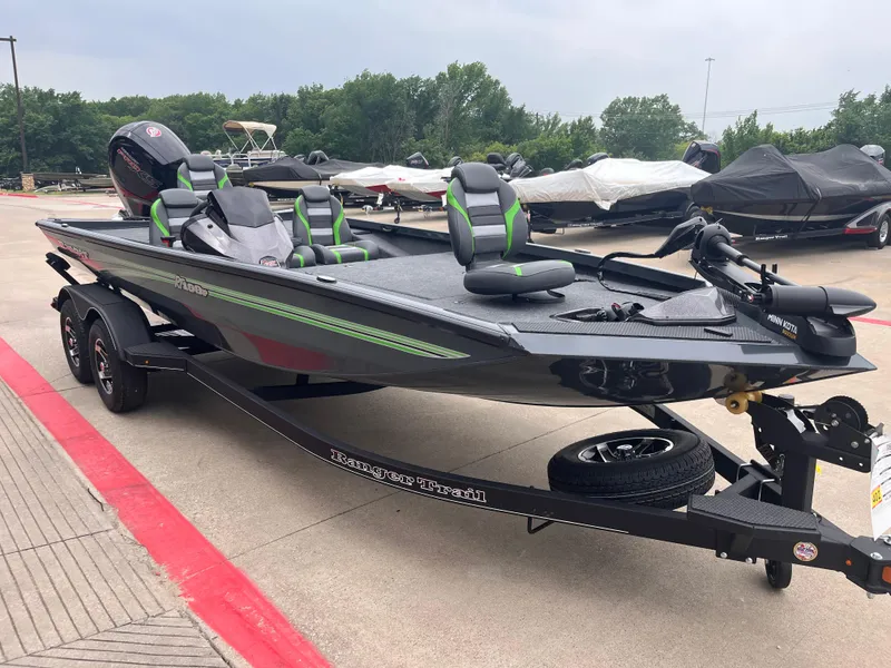 Slide: The Image of 2025 Ranger RT198P boat with green accents on a trailer in a parking lot. - 2