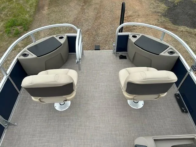 Slide: The Image of 2025 Sun Tracker Bass Buggy 18 DLX pontoon boat interior with swivel seats and cup holders. - 11