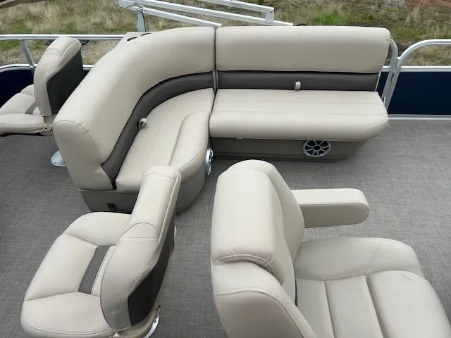 Slide: The Image of 2025 Sun Tracker Bass Buggy 18 DLX pontoon boat with beige seating and spacious layout. - 12