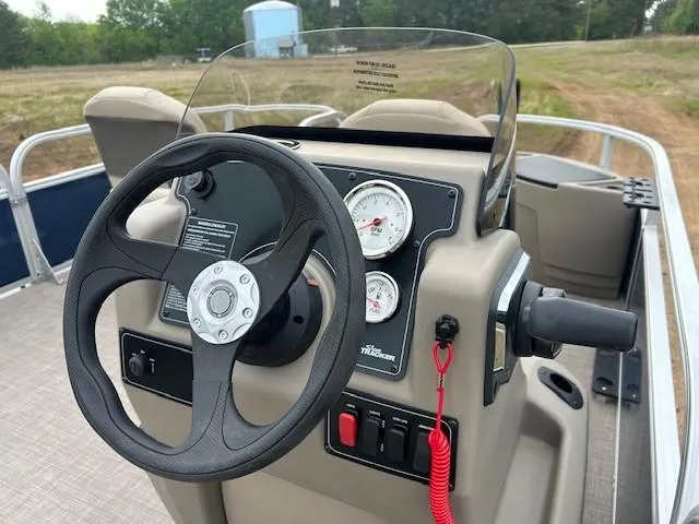 Slide: The Image of 2025 Sun Tracker Bass Buggy 18 DLX dashboard with steering wheel and gauges. - 16