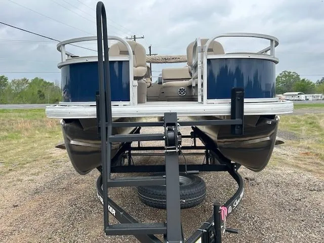 Slide: The Image of 2025 Sun Tracker Bass Buggy 18 DLX pontoon boat on trailer, front view. - 8