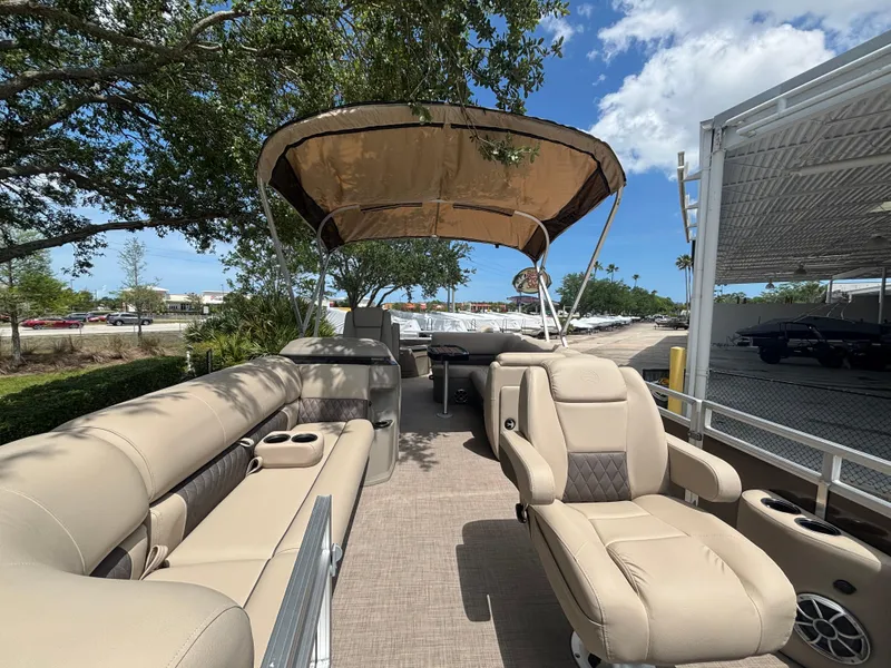 Slide: The Image of 2025 Sun Tracker SportFish 20 DLX pontoon boat with beige seating and canopy. - 4