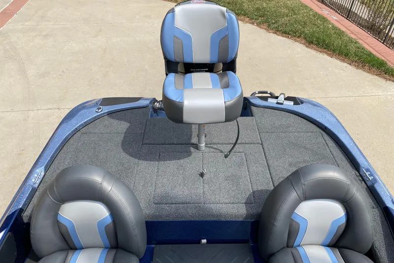 Slide: The Image of 2025 Nitro Z17 boat interior with blue and gray seating on a concrete surface. - 5