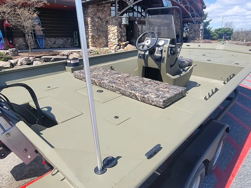 Slide: The Image of 2025 Tracker Grizzly 2072 CC boat with camouflage seating and steering console. - 3