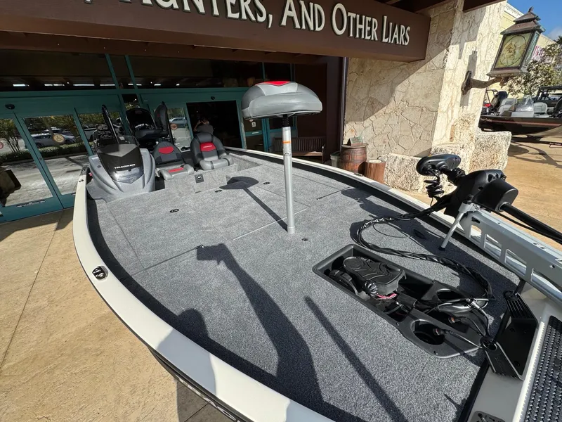 Slide: The Image of 2025 Tracker Savage 215 boat with spacious deck and fishing equipment. - 4