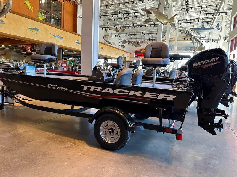 Slide: The Image of 2025 Tracker Pro 170 boat with Mercury engine displayed indoors. - 2