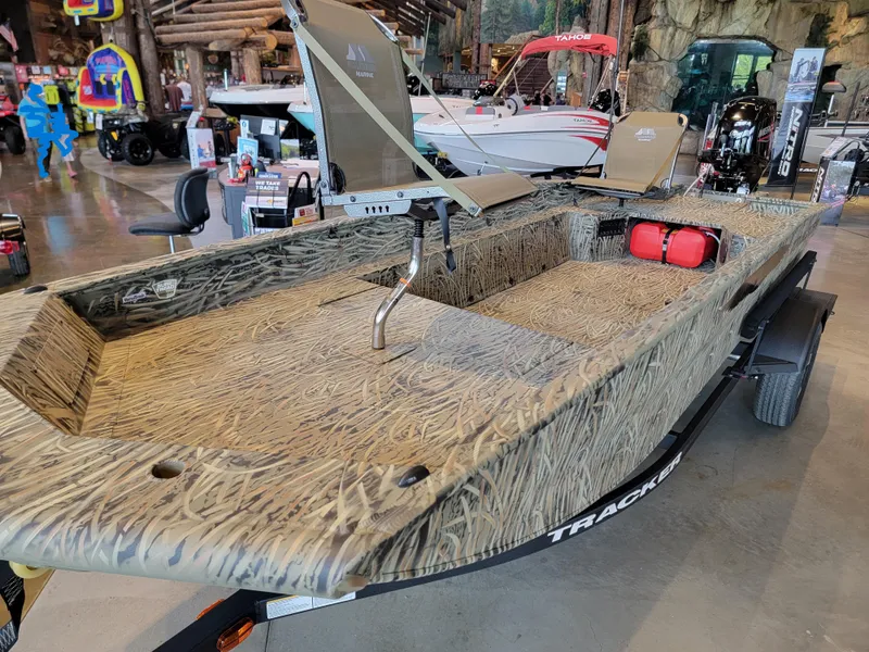 Slide: The Image of 2025 Tracker Grizzly 1650 T Prairie Wings Edition boat with camouflage design in showroom. - 2