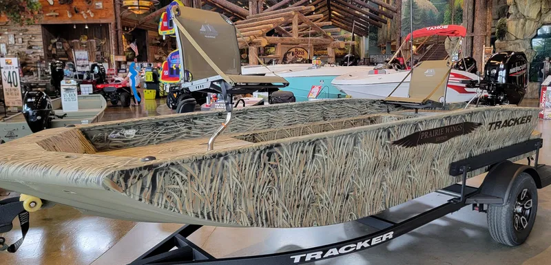 Slide: The Image of 2025 Tracker Grizzly 1650 T Prairie Wings Edition boat with camouflage design on display. - 3