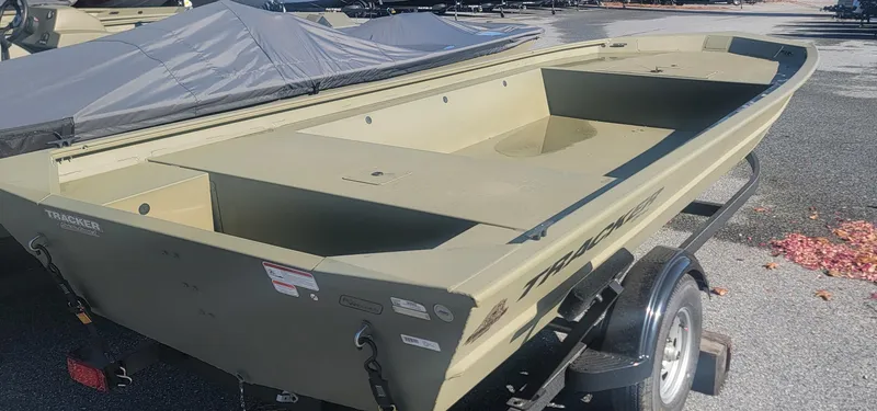Slide: The Image of 2025 Tracker Grizzly 1754 Jon boat on trailer, parked outdoors. - 2