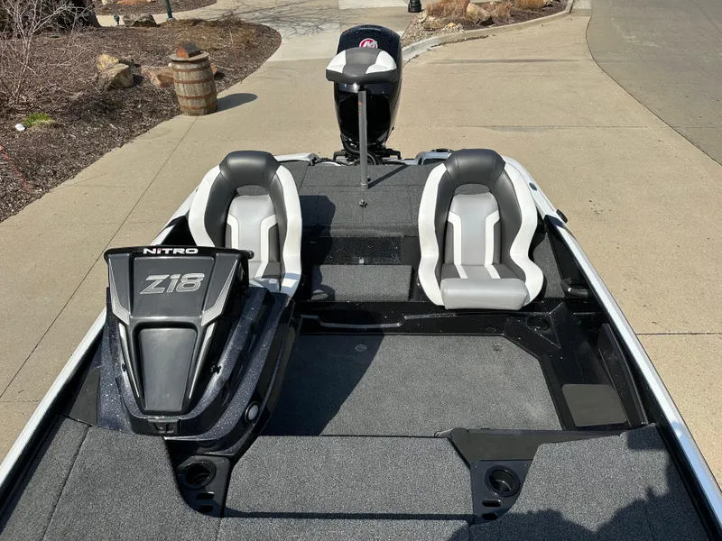Slide: The Image of 2025 Nitro Z18 boat with dual seats and sleek design on a paved surface. - 7