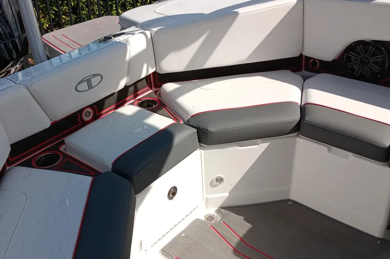 Slide: The Image of 2024 Tahoe 210 S boat interior with cushioned seating and cup holders. - 4