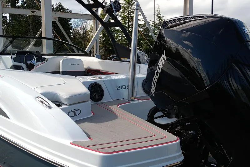 Slide: The Image of 2024 Tahoe 210 S boat with Mercury engine, sleek design, and spacious deck. - 5