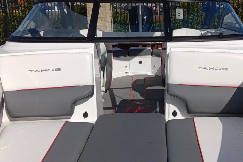 Slide: The Image of 2024 Tahoe 210 S boat interior with gray and white seating, red accents. - 6