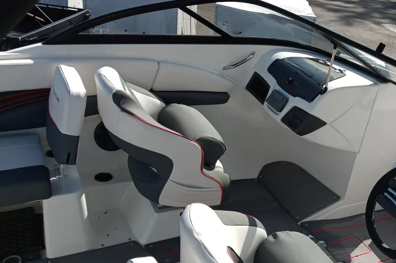 Slide: The Image of 2024 Tahoe 210 S boat interior with modern seating and dashboard design. - 8