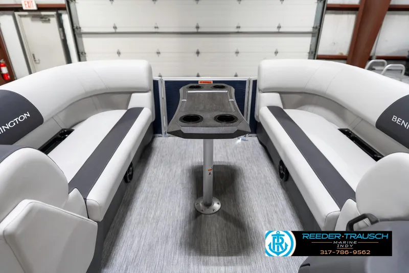 Slide: The Image of 2025 Bennington 22 SSR boat interior with gray seating and central table. - 21