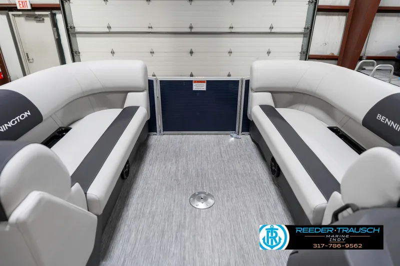 Slide: The Image of 2025 Bennington 22 SSR boat interior with gray seating and flooring in a garage setting. - 22