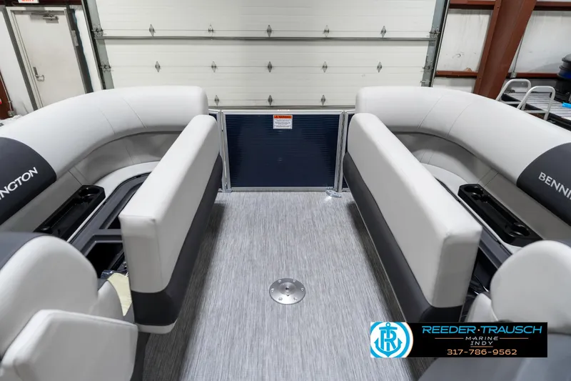 Slide: The Image of 2025 Bennington 22 SSR boat interior with gray seating and flooring in a garage. - 23